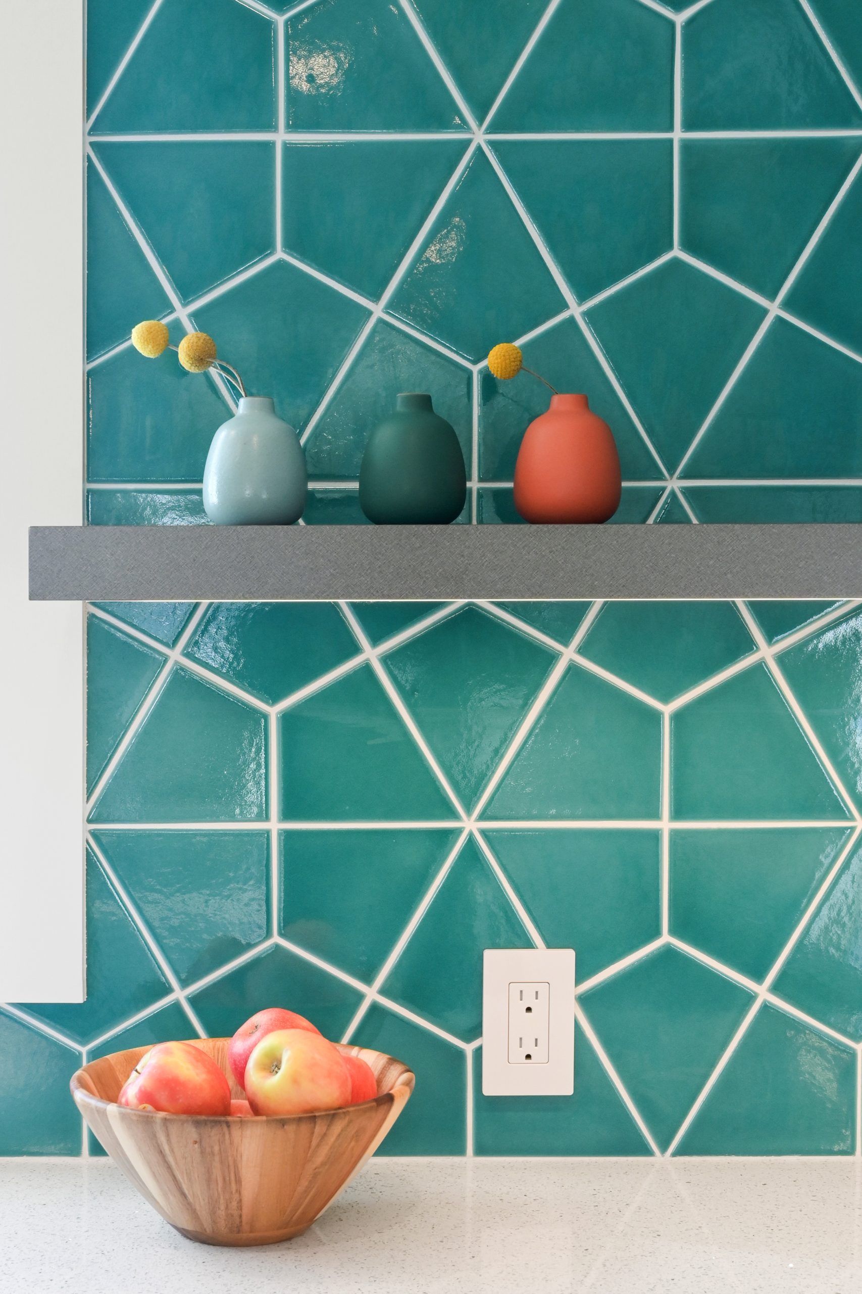 teal tile backsplash with gray shelf