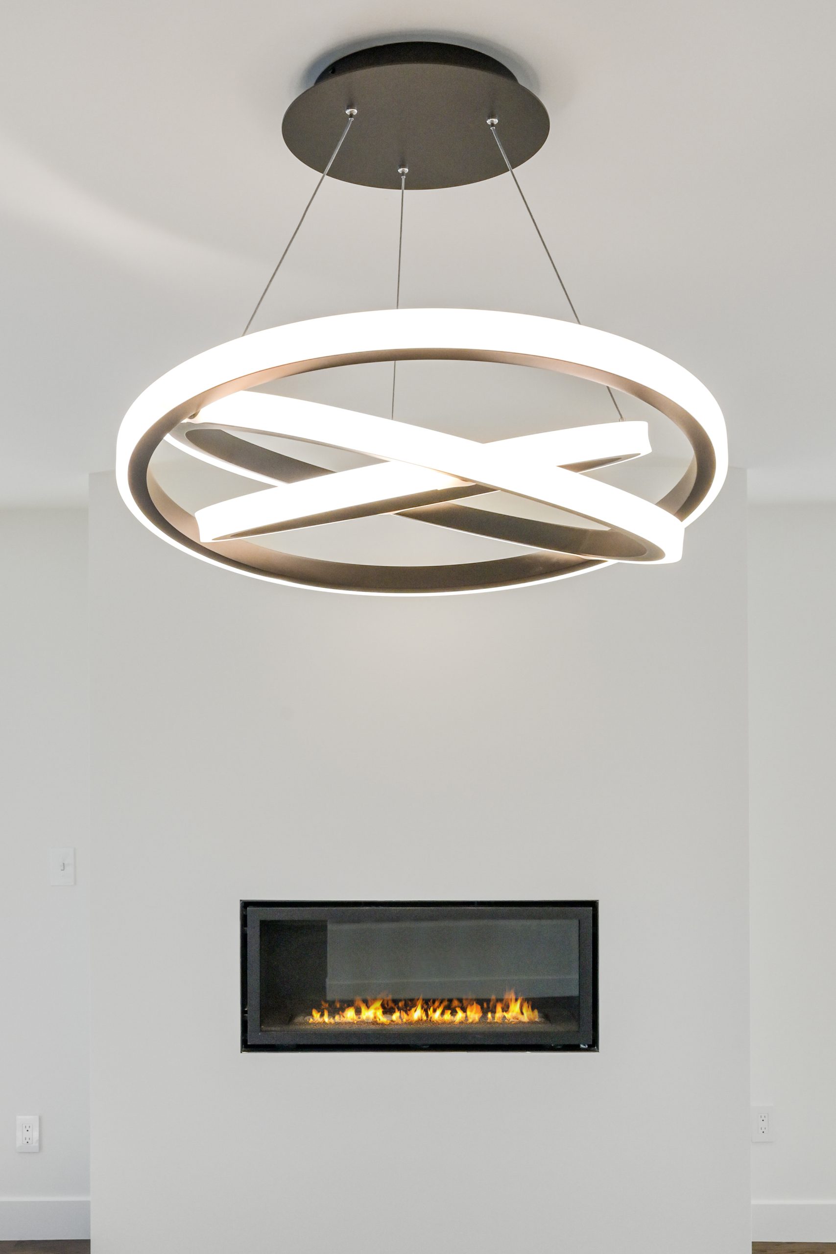 living room ceiling light fixture above a fireplace